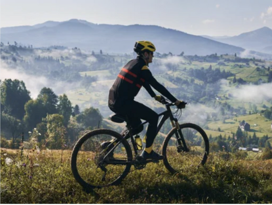 Cyclist riding electric bike outdoors on scenic mountain trail, Pogo Cycles e-bike adventure