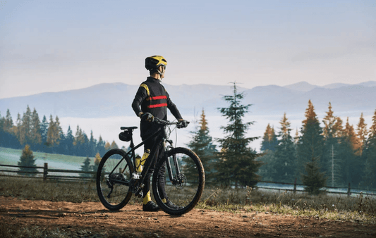 Cyclist with electric bike outdoors, forest background, Pogo Cycles e-bike riding scene